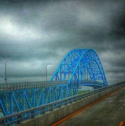 View of bridge against cloudy sky