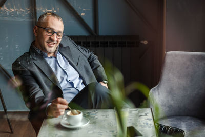 Mid adult man sitting at table