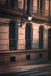 Low angle view of street light against building