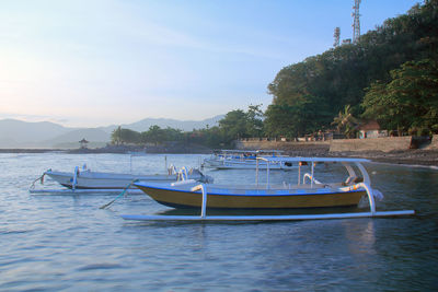 Boat moored in sea against sky