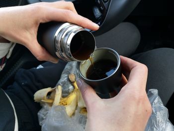 Midsection of person holding coffee cup