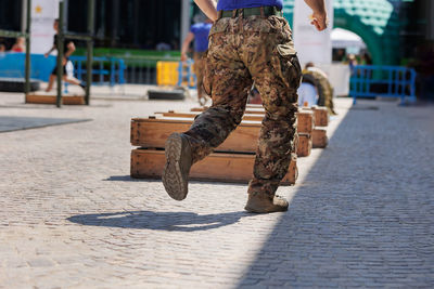 Low section of man standing on street