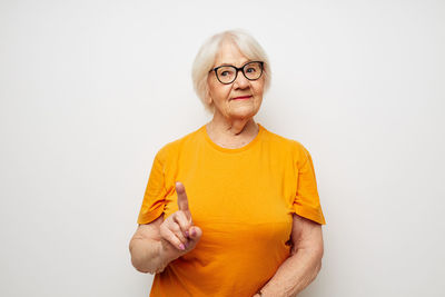 Portrait of young woman gesturing against white background