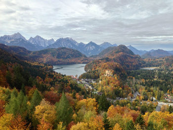 High angle view of lake surrounded by mountains against sky