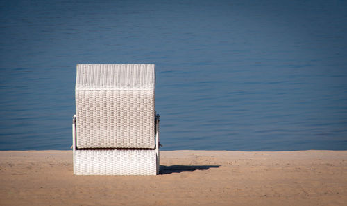 Hooded chairs on table at beach