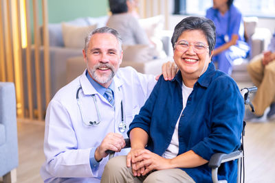 Portrait of female doctor examining patient in hospital