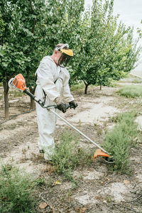 Rear view of man working on field