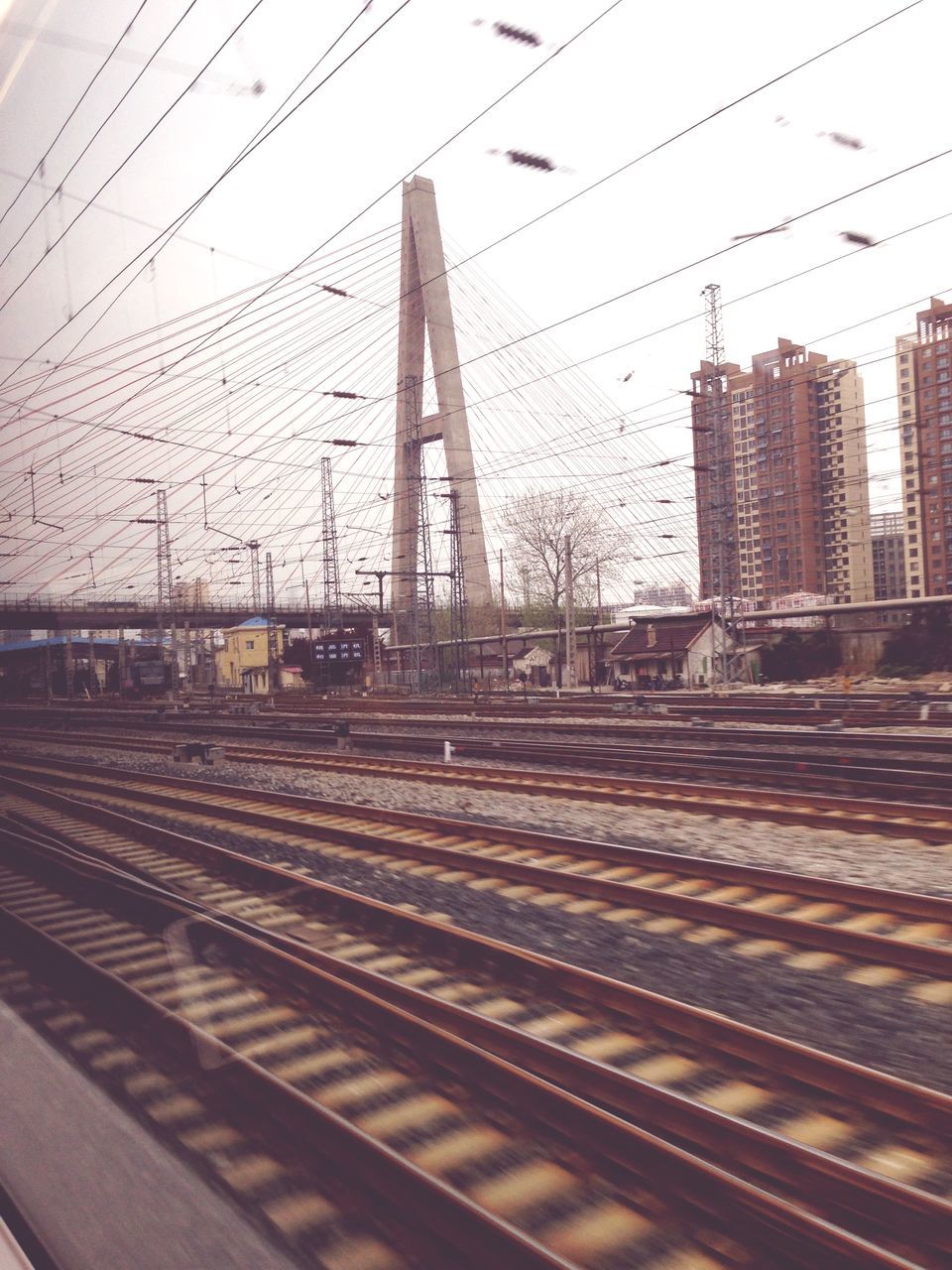 railroad track, transportation, rail transportation, public transportation, built structure, architecture, building exterior, city, railroad station, clear sky, connection, railroad station platform, railway track, train - vehicle, sky, travel, mode of transport, diminishing perspective, no people, day