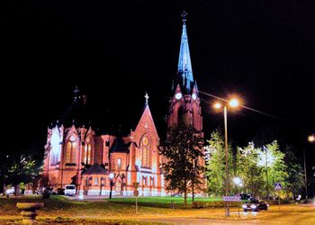 Low angle view of illuminated church against sky at night