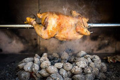 Close-up of meat hanging on barbecue