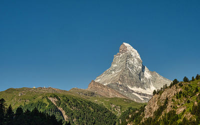 Scenic view of mountains against clear blue sky