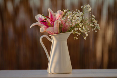 Close-up of pink flower vase on table