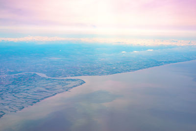 Aerial view of sea against sky during sunset