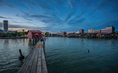 Scenic view of sea by buildings against sky