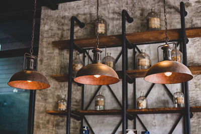 Close-up of illuminated pendant lights hanging on wall