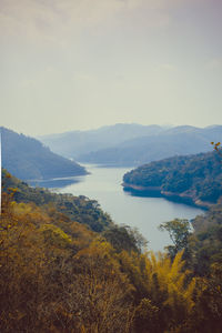 Scenic view of sea and mountains against sky