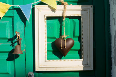 Close-up of clothes hanging on blue door