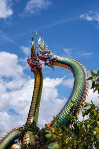 Low angle view of carousel against sky