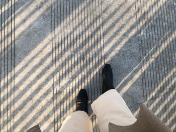 Low section of woman on street in city