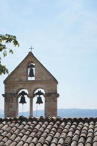 High section of bell tower against sky