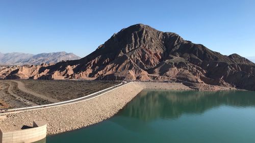 Scenic view of mountains against clear blue sky