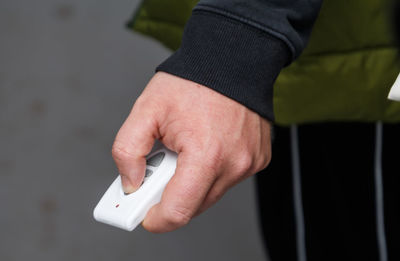 Midsection of man using mobile phone