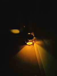 Close-up of illuminated lamp on table