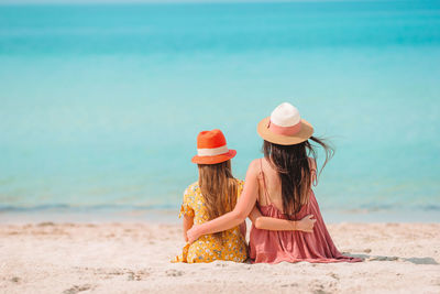 Rear view of woman with umbrella on beach