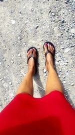 Low section of woman standing on ground