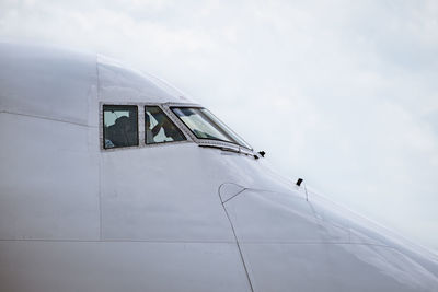 Low angle view of airplane flying against sky
