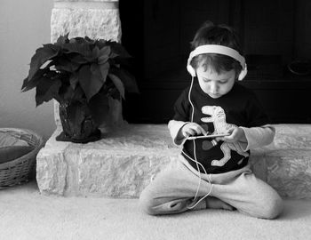 Boy listening to music through mobile phone