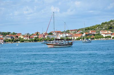 Boats in water against sky