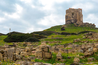 Ruins of building against cloudy sky