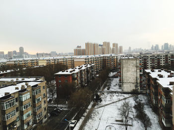 High angle view of buildings against sky during winter