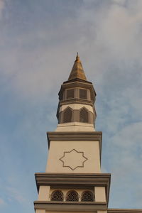 Low angle view of clock tower against sky