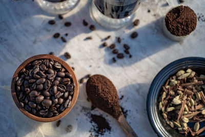 Still life with glass mugs of black hot coffee, coffee beans,  coffee at home