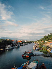 High angle view of river and buildings against sky