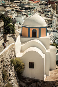 High angle view of cross amidst buildings in city