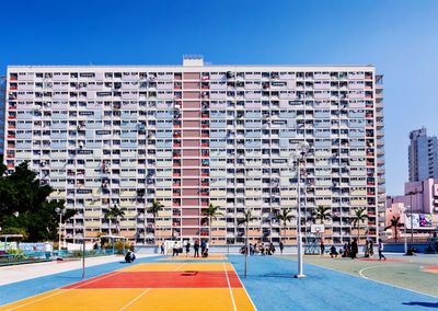 Basketball court against buildings in city