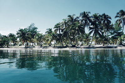 Swimming pool by sea against sky