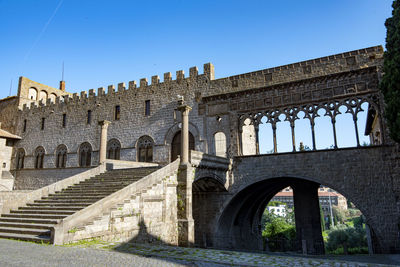 Low angle view of old ruins against clear blue sky