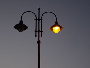 Low angle view of street light against sky