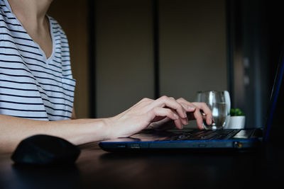Caucasian woman typing with laptop keyboard at home office workplace. freelancer remotely working