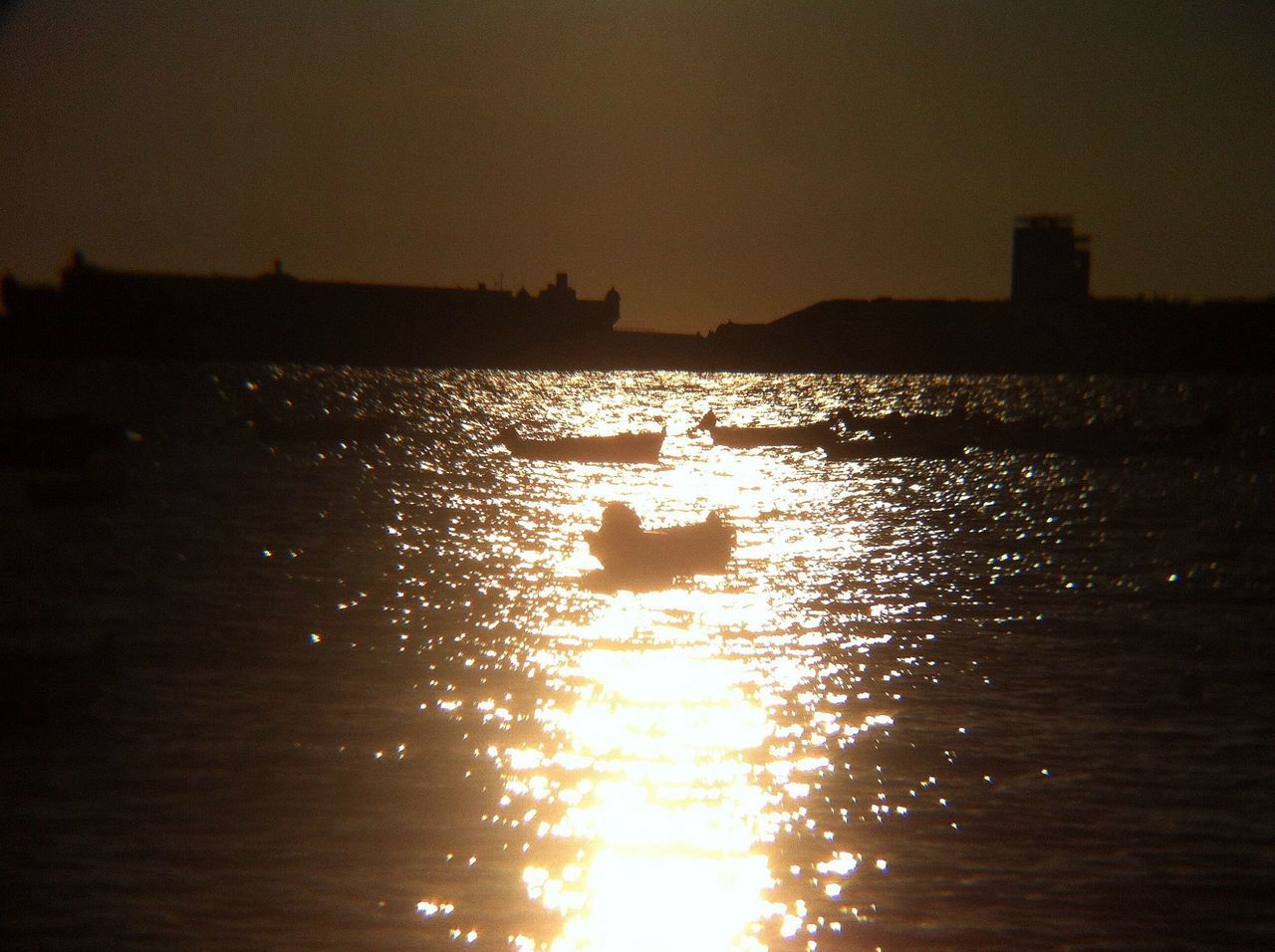 sunset, water, silhouette, sea, waterfront, sun, nautical vessel, scenics, tranquil scene, reflection, tranquility, transportation, beauty in nature, orange color, boat, rippled, nature, mode of transport, idyllic, sky