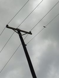 Low angle view of power lines against sky