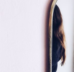 Close-up of woman against wall