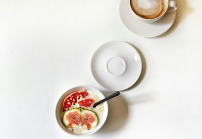Directly above shot of breakfast on table against white background