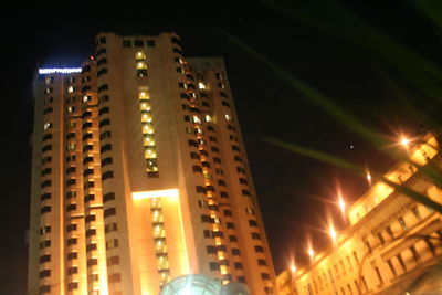 Low angle view of modern building against sky at night