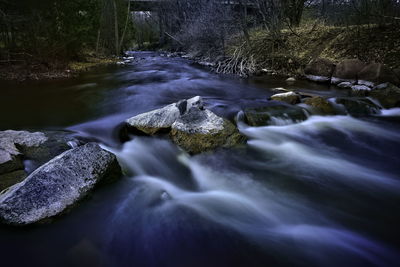 Stream flowing through rocks in forest