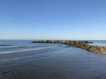 Scenic view of sea against clear blue sky